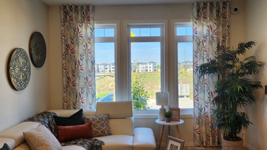 Custom floral drapery panels in a living room in Winnipeg done by Superblinds.